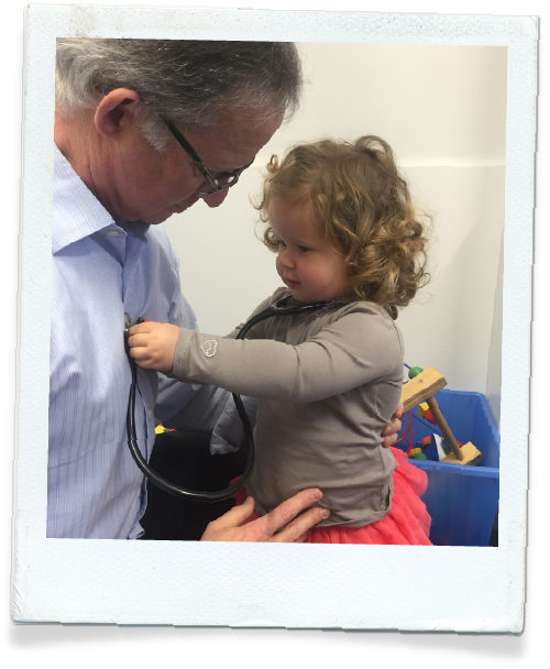 Dr Leon Levitt at baby Steps Health Centre with his granddaughter